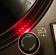 Abstract stroboscopic dots lit in red on top of a record